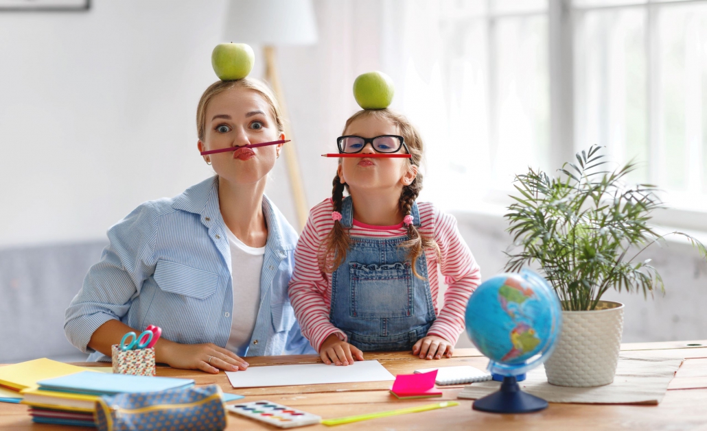 Mum and daughter have fun doing homework Mum and daughter have fun doing homework