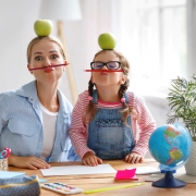Mum and daughter have fun doing homework