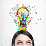 Woman with black hair and colorful light bulb