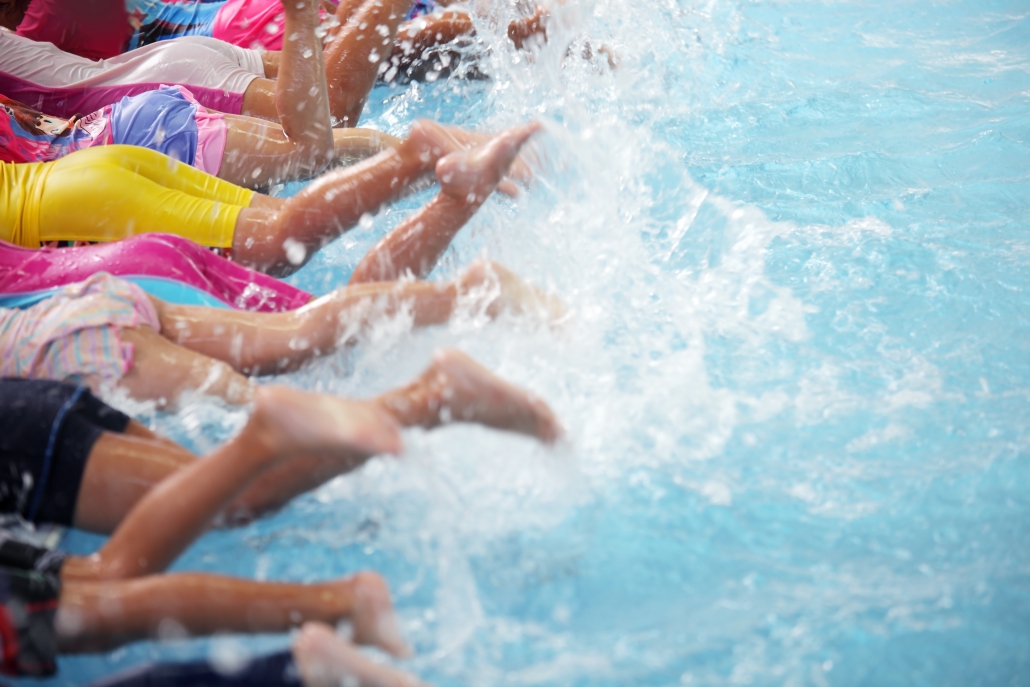Children splashing leisure centre swimming pool