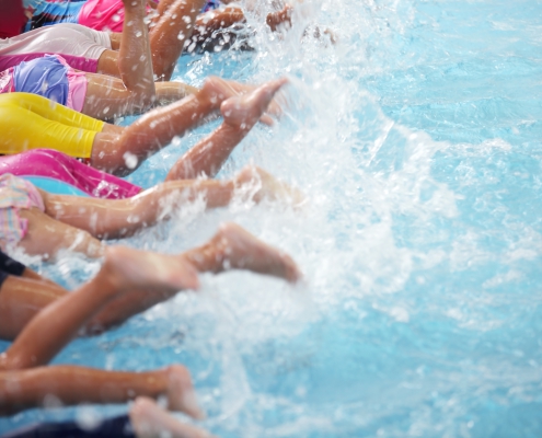 Children splashing leisure centre swimming pool