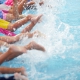 Children splashing leisure centre swimming pool