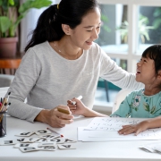 mother teaching her daughter the basic to read and write