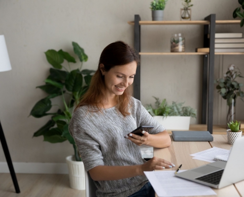 Happy homeworker reading employee engagement text