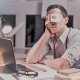 Bored office worker pretending to be asleep